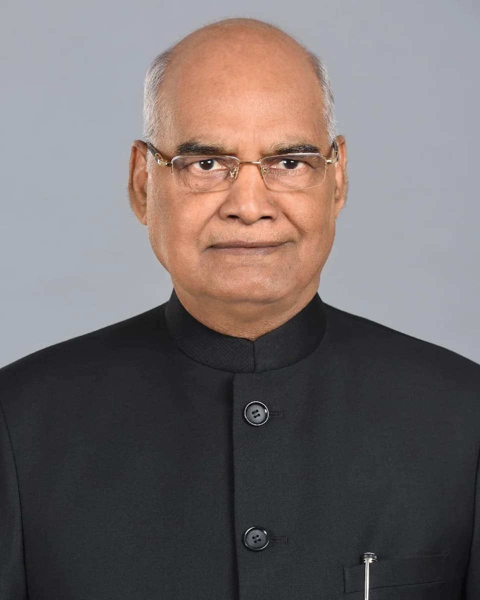 Ram Nath Kovind in glasses and a black jacket against a grey background