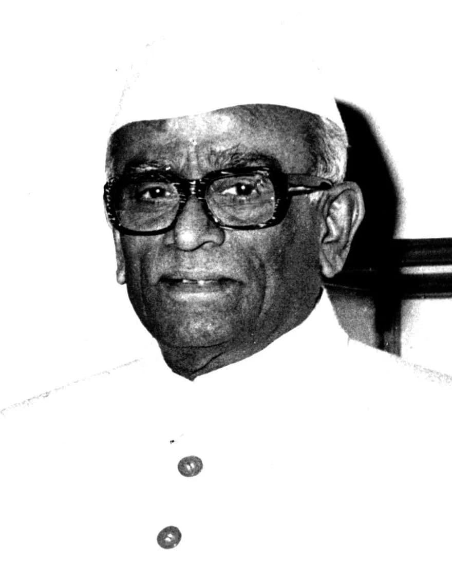 Neelam Sanjiva Reddy in a white cap and thick-framed glasses, black-and-white photograph