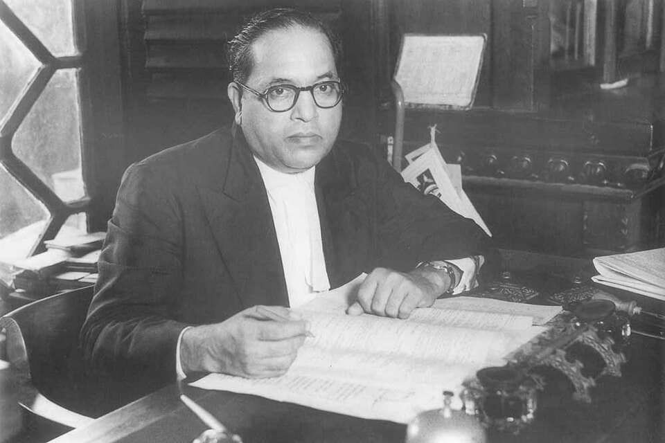 B. R. Ambedkar seated at his desk in 1950