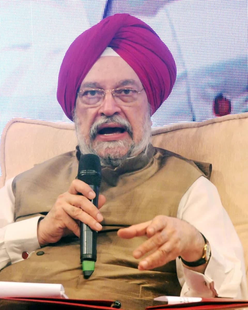 Hardeep Singh Puri in a turban and waistcoat, speaking into a microphone