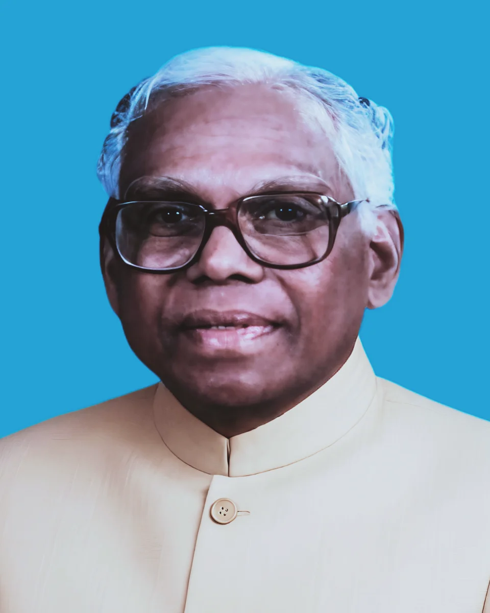 K. R. Narayanan in glasses and a cream jacket against a blue background